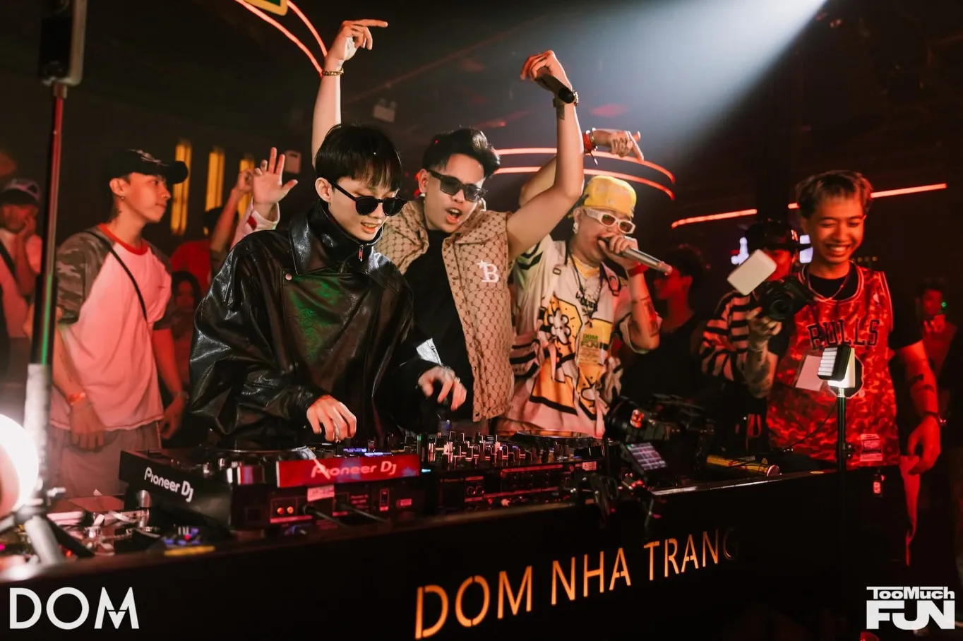 Guest DJs and an MC performing behind the DOM Nha Trang booth